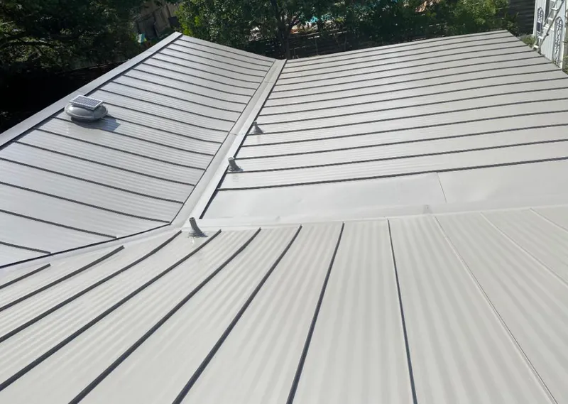 Solar attic fan installed on a metal roof for Roof Ventilation in Brandon